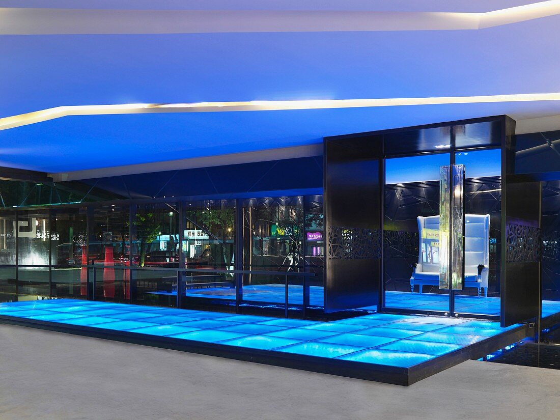 Covered entrance area with a floor made of illuminated glass panels