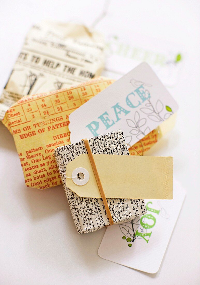 Small parcels wrapped in newspaper with labelled tags on table