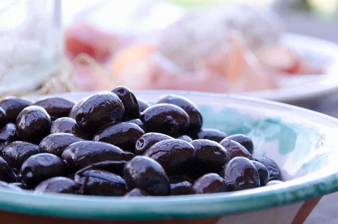 Black olives in a ceramic bowl