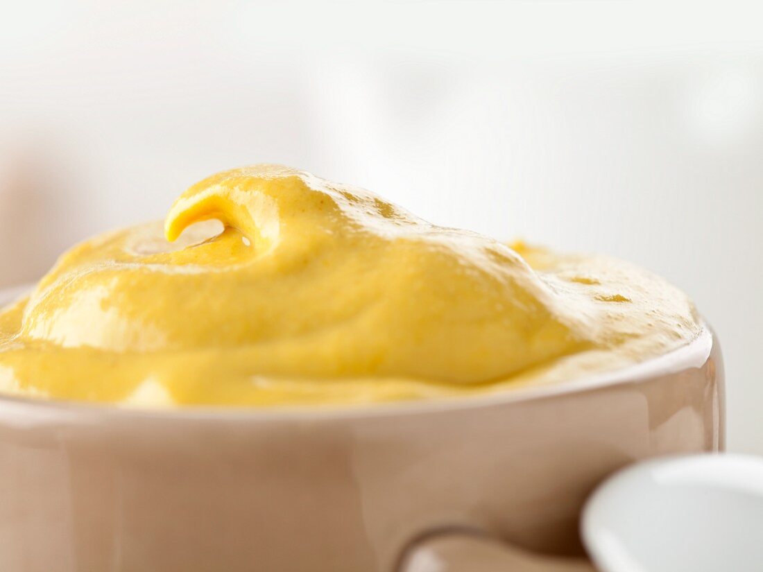 Medium hot mustard in a mustard pot (close-up)