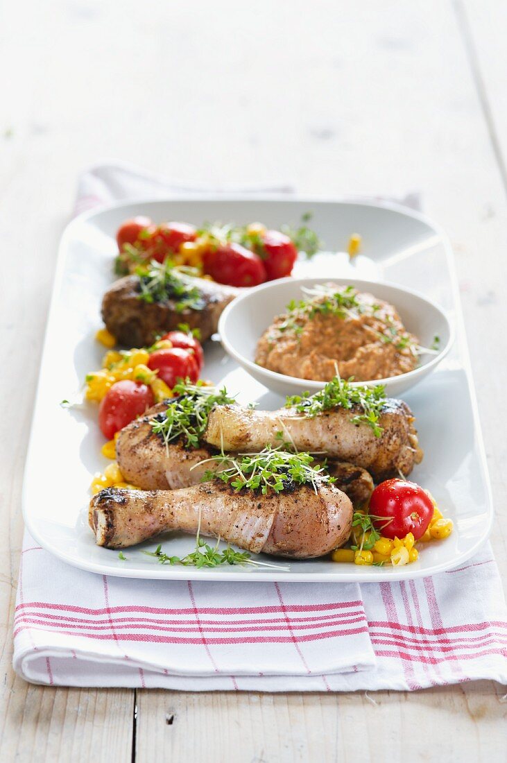 Chicken legs with cress, tomatoes, sweetcorn and a romanesco dip