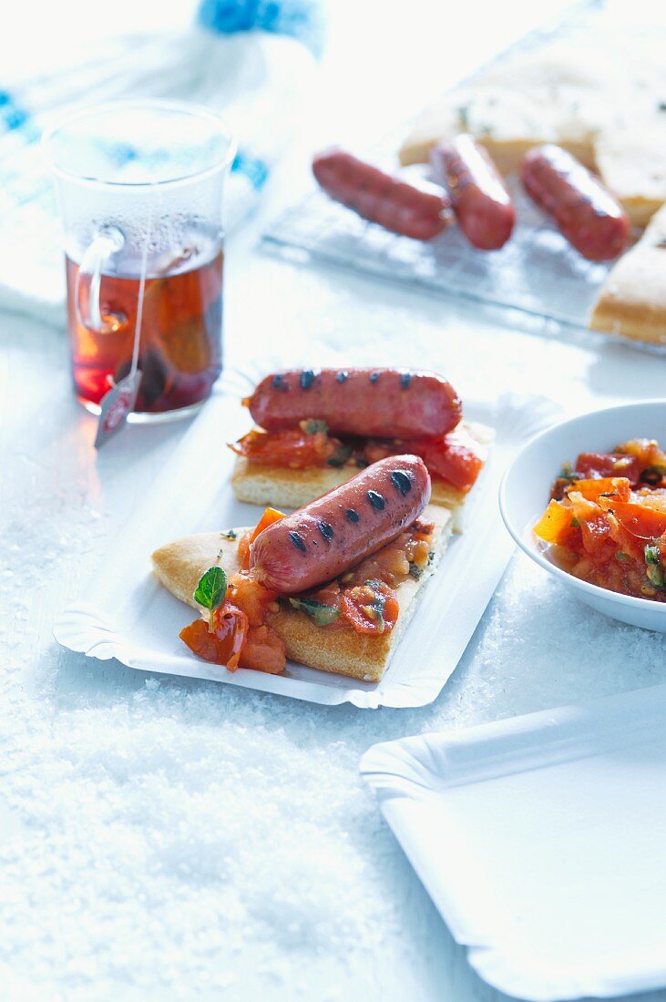 Focaccia topped with tomatoes and sausages