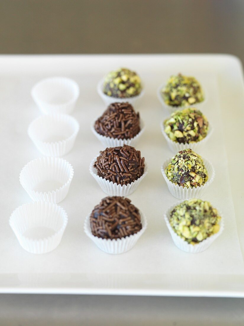 Truffle pralines decorated with chocolate sprinkles and pistachios