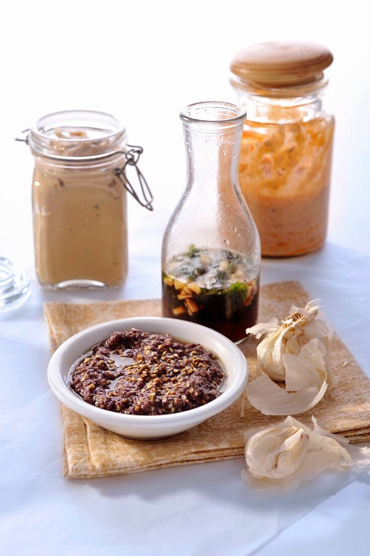 Various dressings and tapenade with sesame seeds