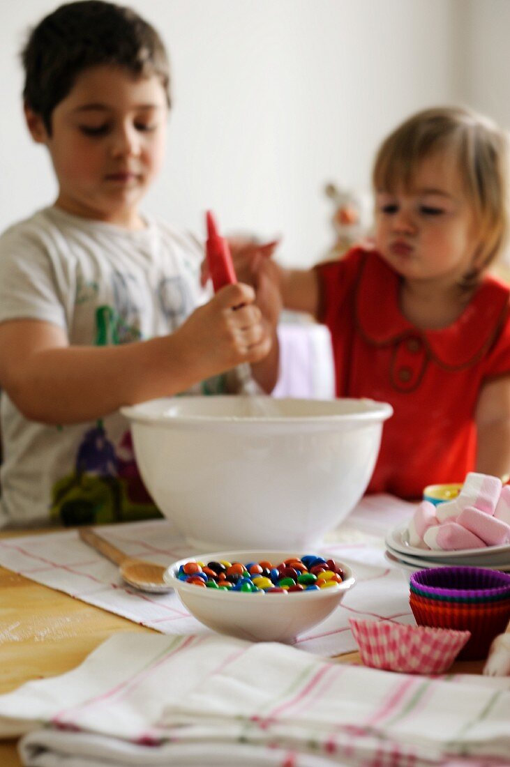 Young boy and girl mixing ingredients in a bowl