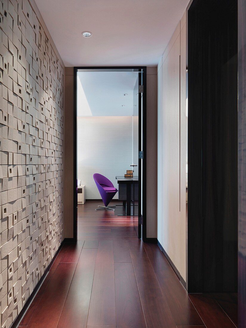 Purple chair at desk at end of hallway