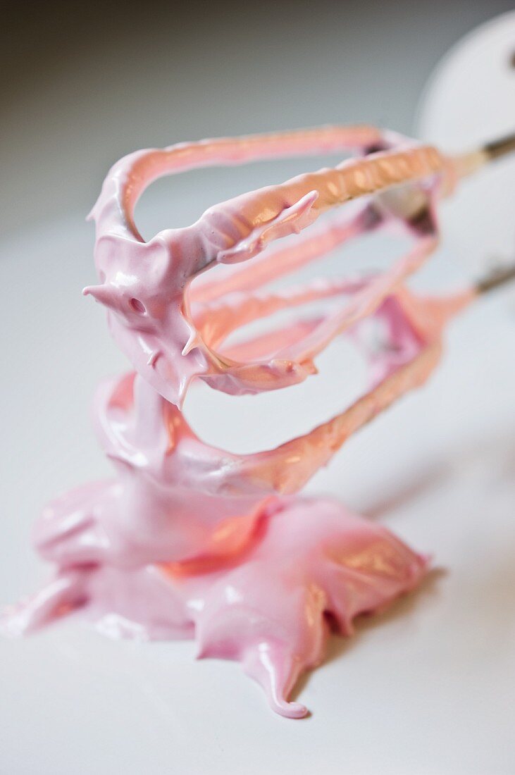 Pink meringue on an electric whisk