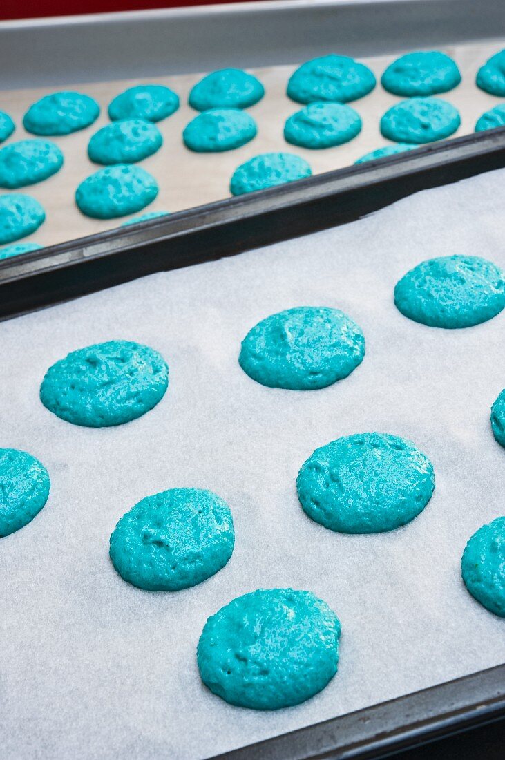 Piles of blue macaroon dough on baking paper