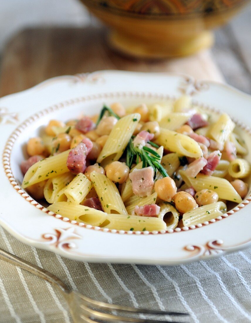 Penne pasta with chickpeas, pancetta and rosemary