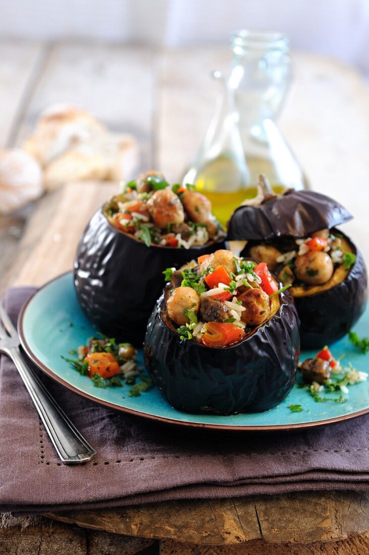 Baked aubergines stuffed with rice, roasted sweet peppers and mini lamb meatballs