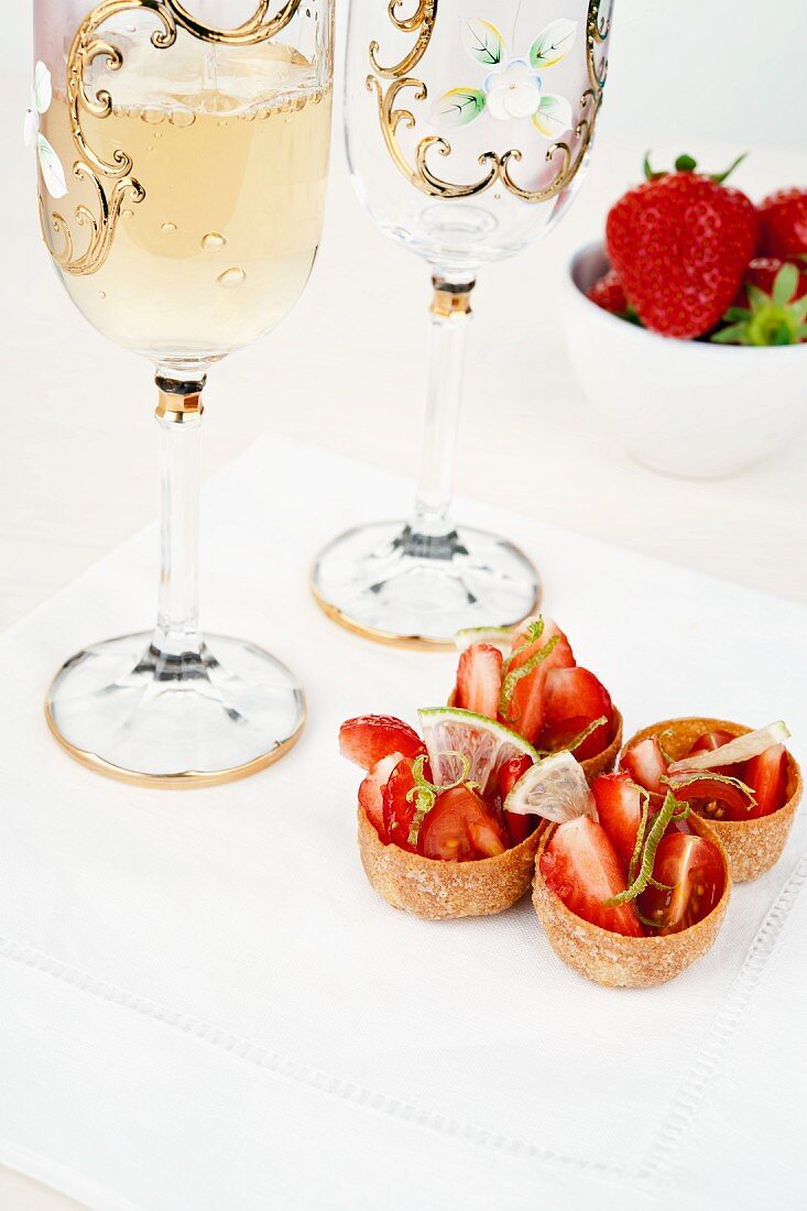 Strawberries and cherry tomatoes in a lime and olive oil marinade served in edible bowls