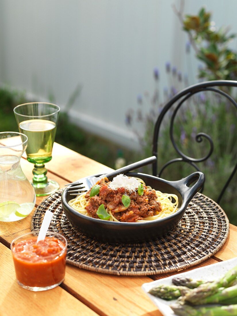 Spaghetti bolognese on a garden table