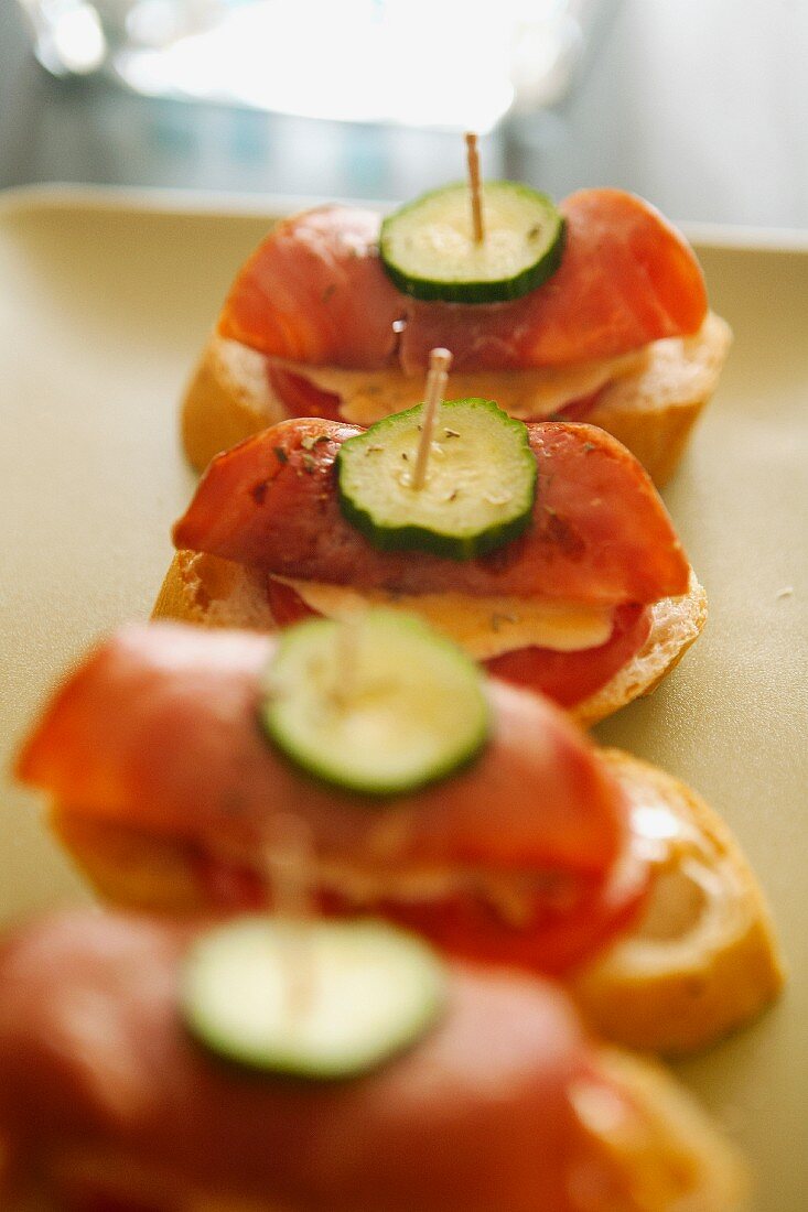 Canapes with ham, tomatoes and cucumber