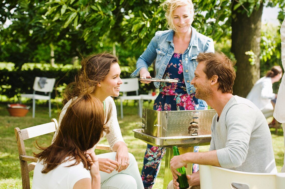 Young people chatting at a barbecue
