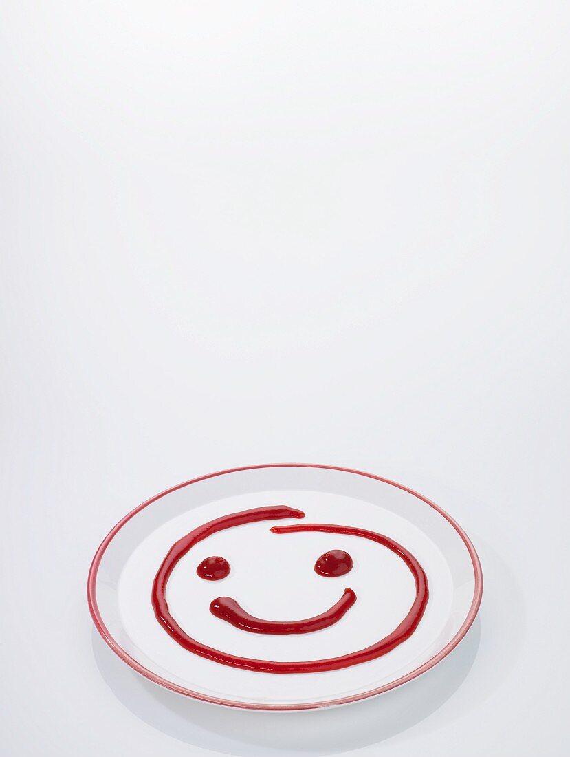 A ketchup smiley on a plate
