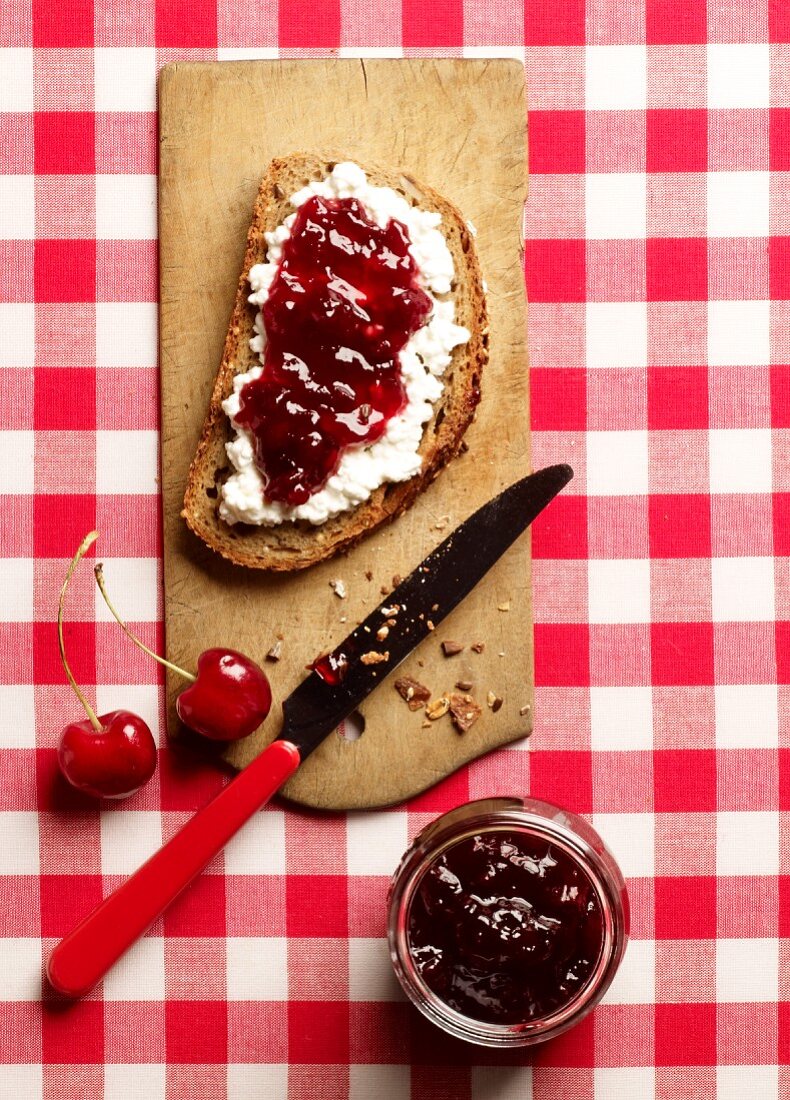 Rustic bread topped with cream cheese and cherry jam