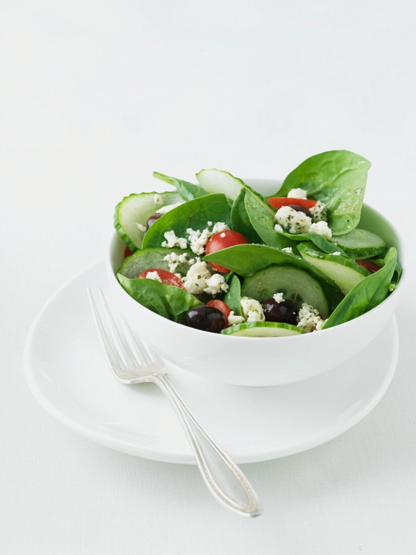 Bowl of Greek Salad with Baby Spinach, Feta Cheese, Olives and Tomatoes