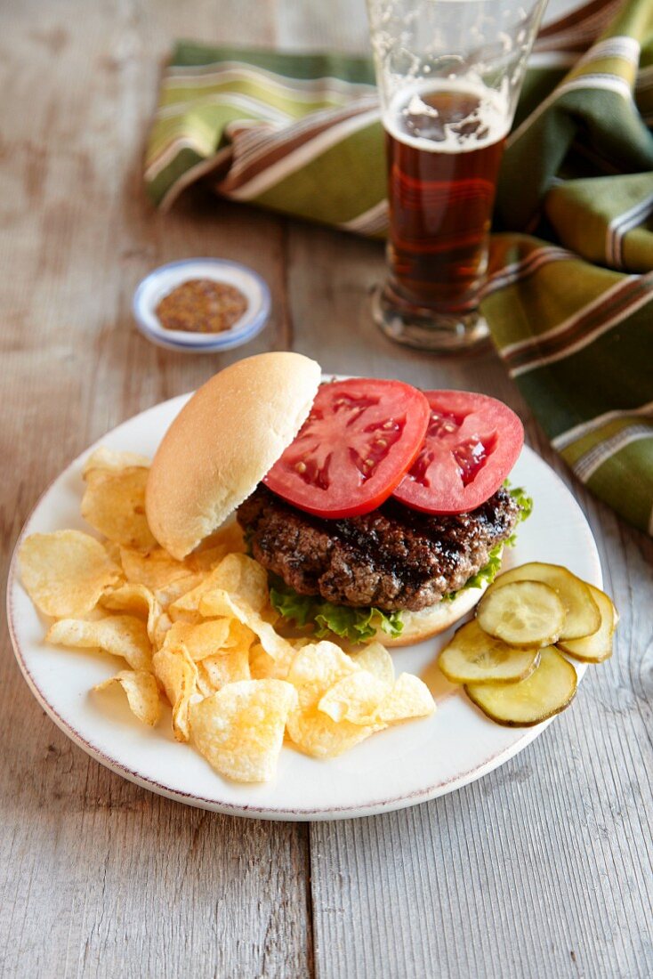 Hamburger mit gegrilltem Büffelfleisch, Chips und Bier