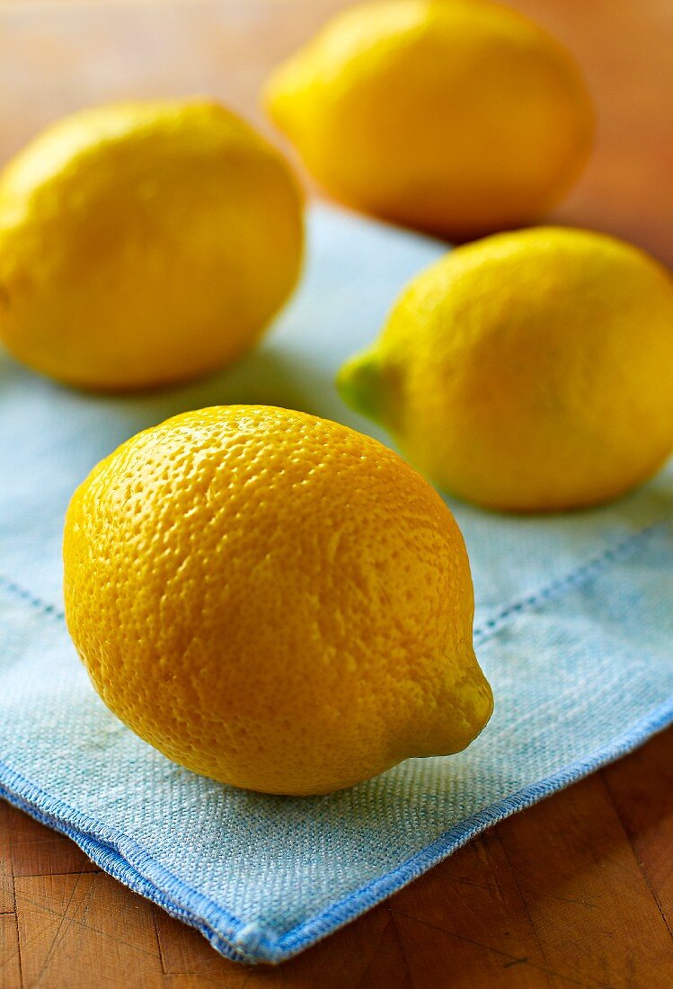 Four Whole Lemons on Blue Linen Napkin