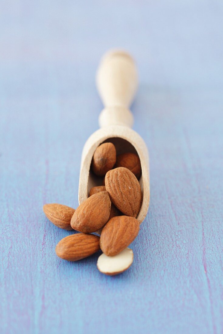 Almonds on a wooden scoop