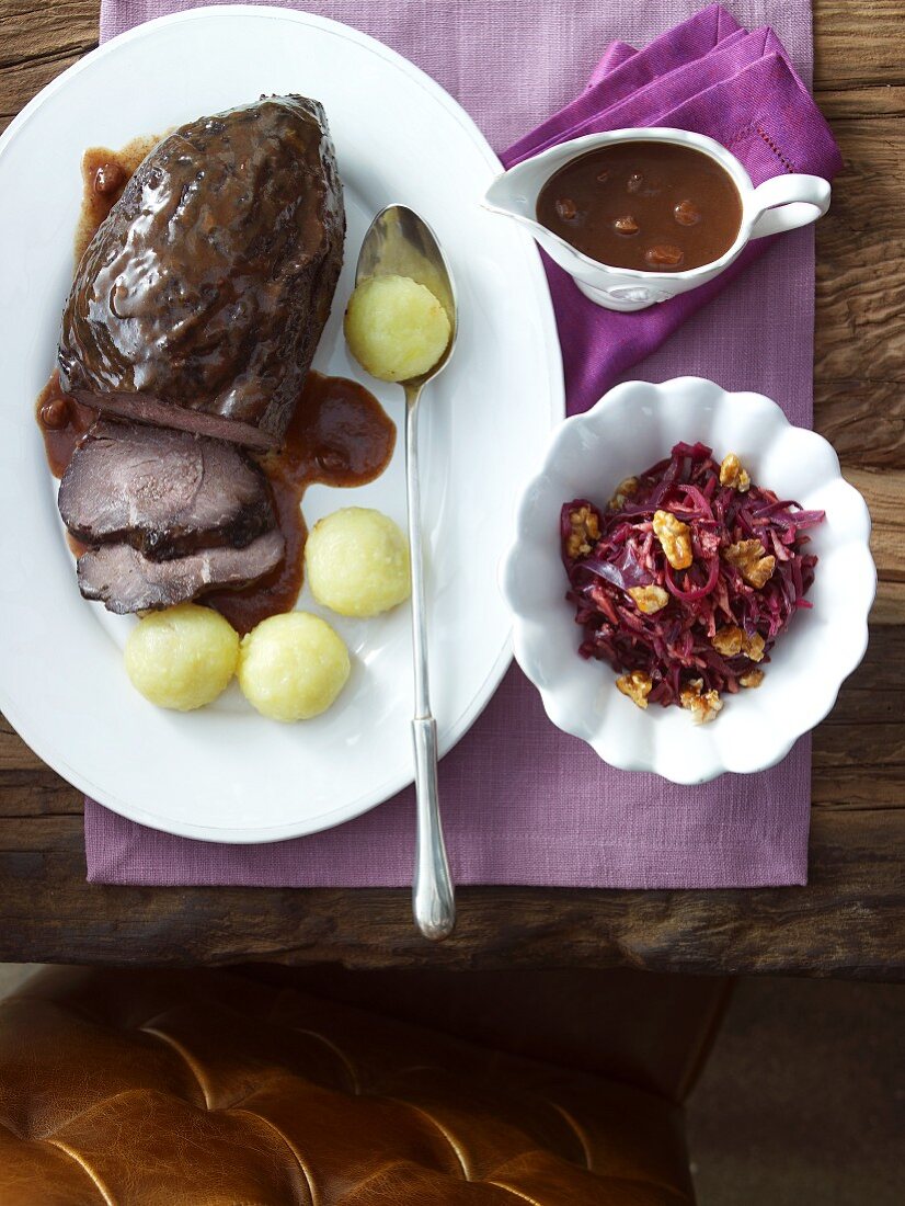 Marinated pot roast with raisin sauce, dumplings and red cabbage salad