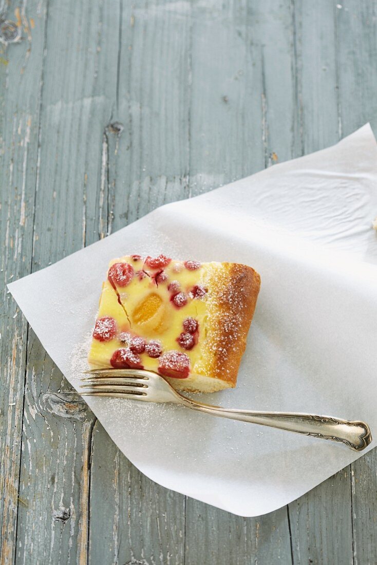 A slice of vanilla cream and summer fruit cake