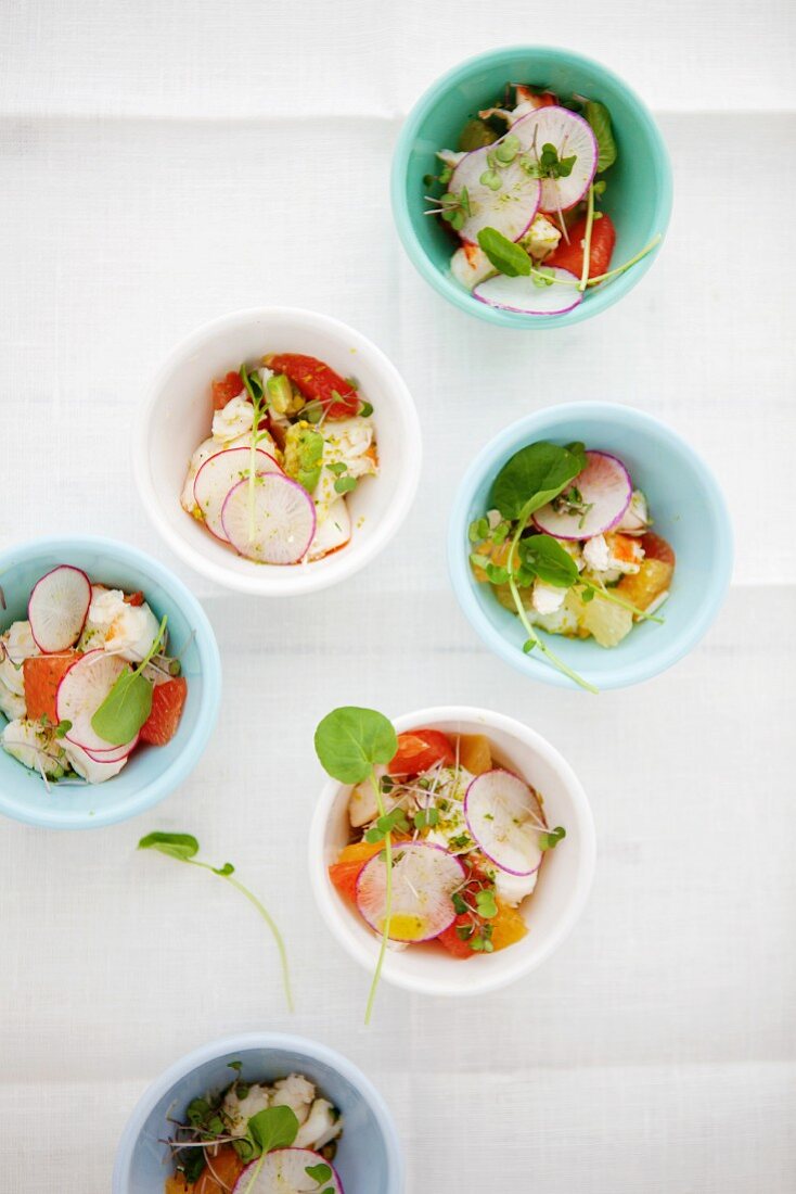 Lobster salad with citrus fruits and radishes in cups
