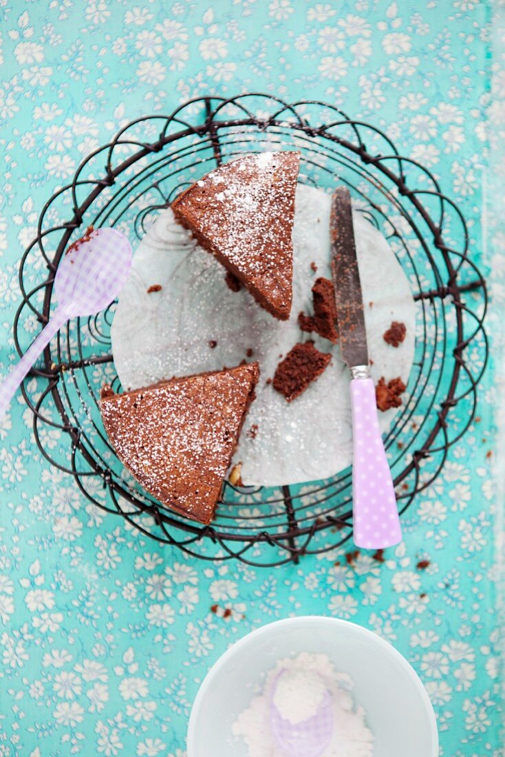 Two slices of chocolate cake on a wire rack