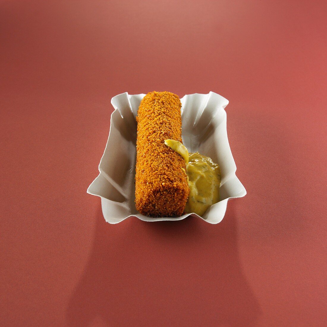 A meat croquette with sweet mustard (Holland)