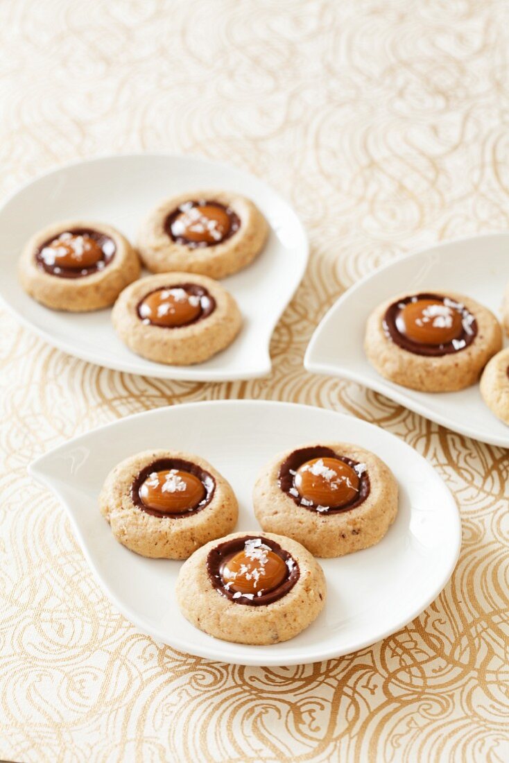 Sandies Cookies with Caramel and Chocolate on Small White Dishes