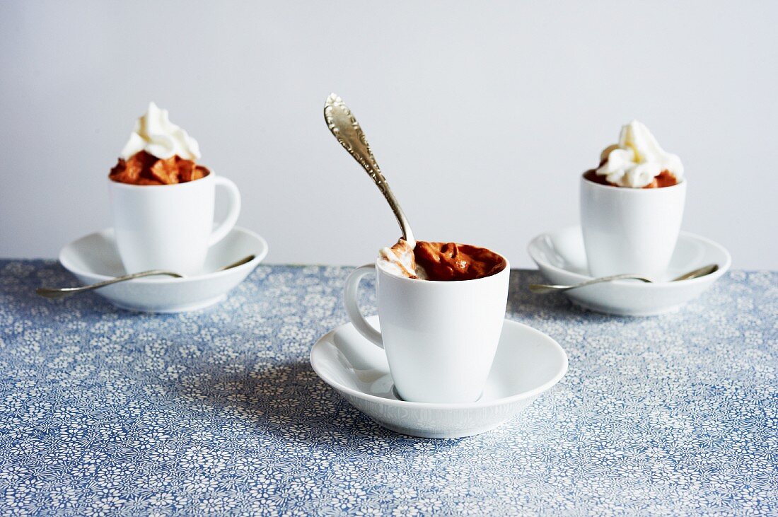 Chocolate Mousse in Cups on Saucers with Whipped Cream