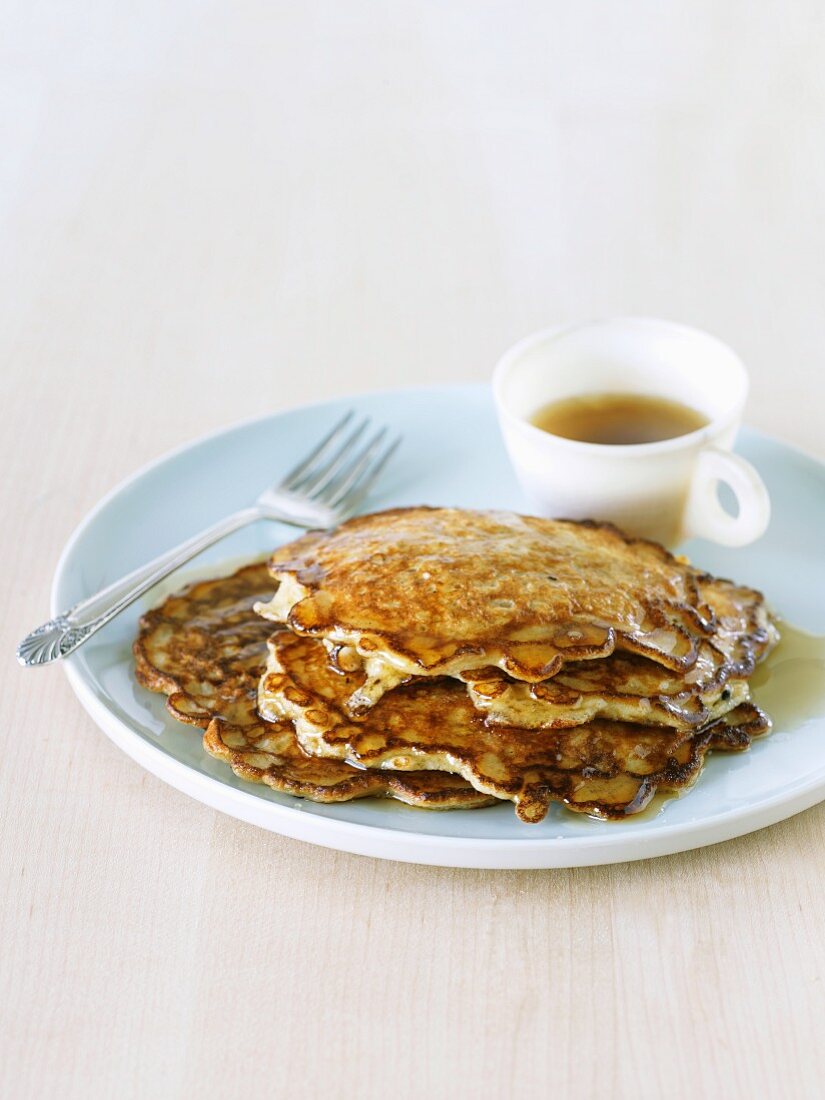 Stack of Oatmeal Pancakes with Maple Syrup on a Plate with a Fork