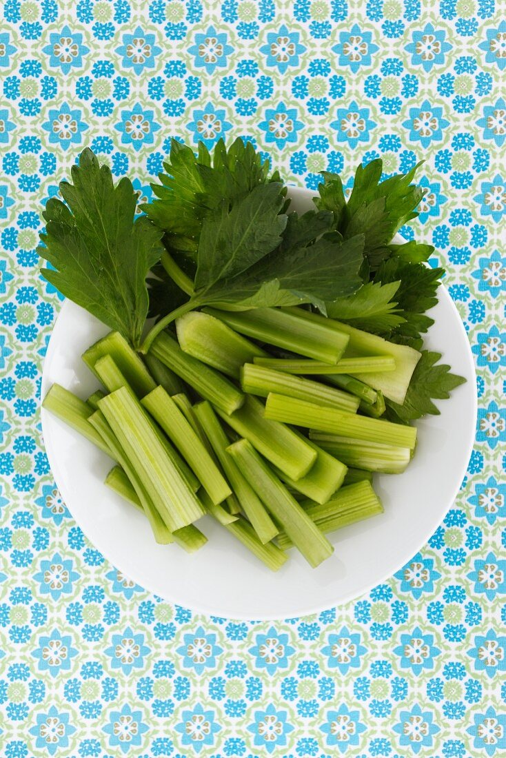 A plate of fresh celery, sliced (seen from above)