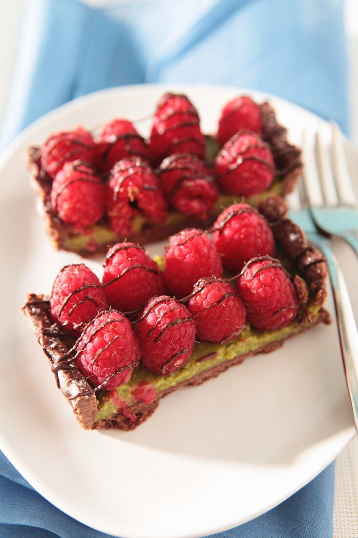 Two slices of raspberry tart with chocolate