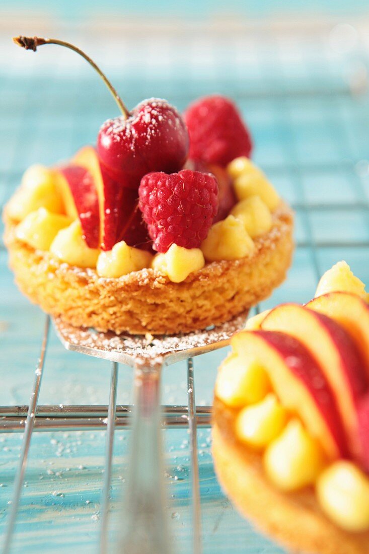 Fruit tartlets with raspberries, cherries and peaches