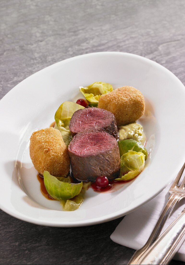 Venison fillets with potato croquettes, Brussels sprouts puree and lingonberries