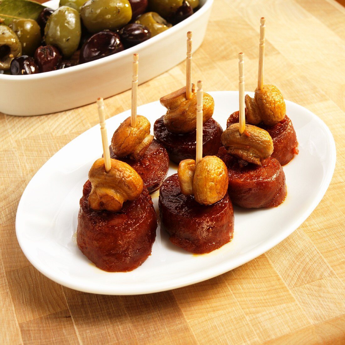 Small Dish of Chorizo and Mushroom Appetizers with Toothpicks