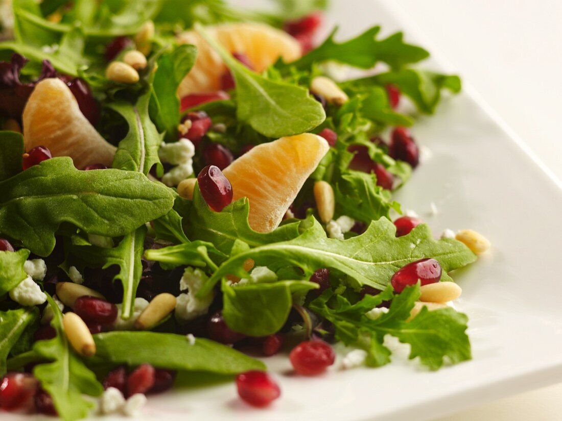 Fresh Salad with Pomegranate Seeds, Pine Nuts and Clementine Segments