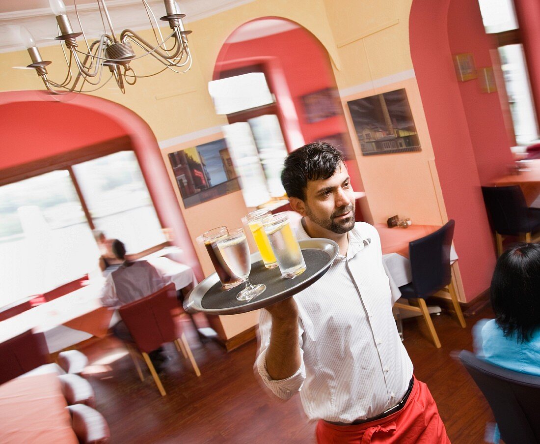 Male waiter with drinks in hand