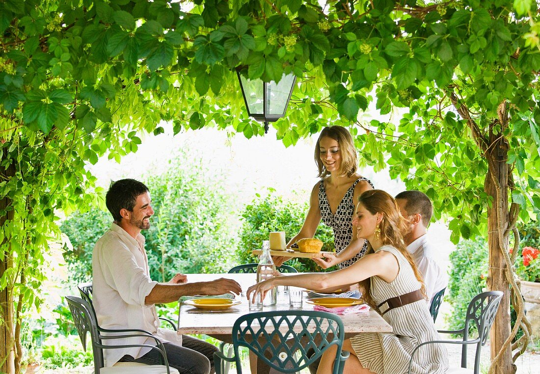 Group enjoying meal in garden