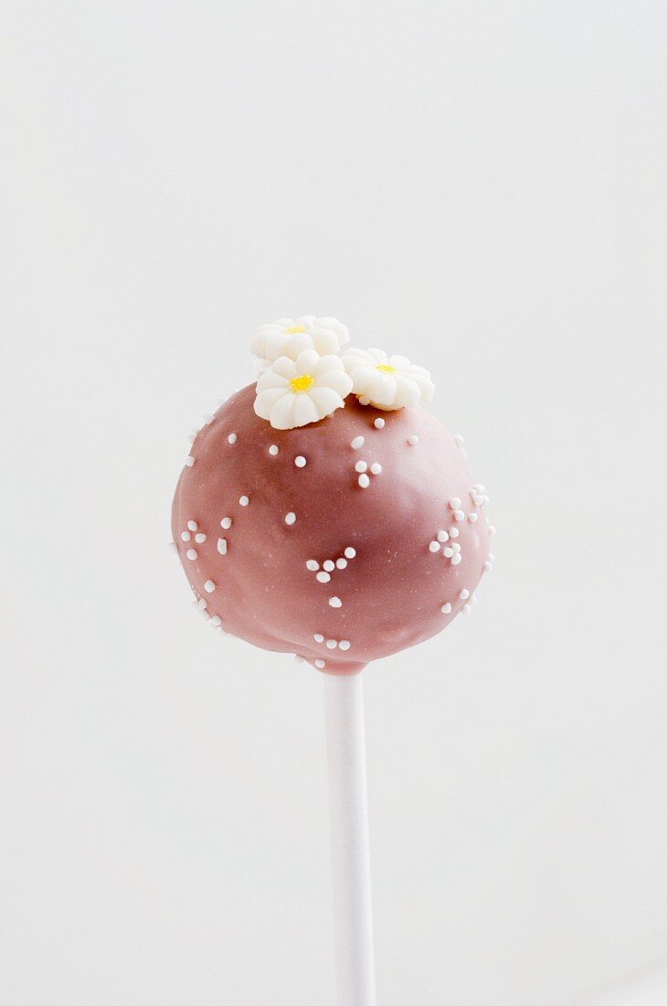 Pink Cake Pop with white sugar pearls and flowers