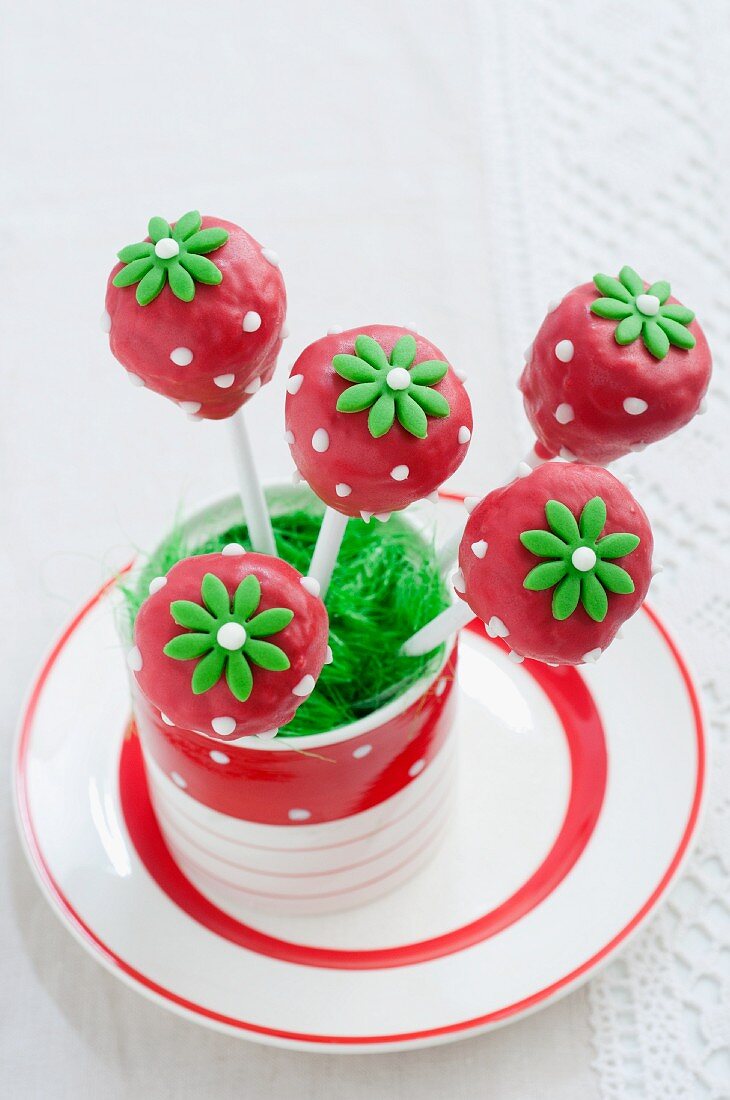 Cake Pops (decorated like strawberries) in a glass