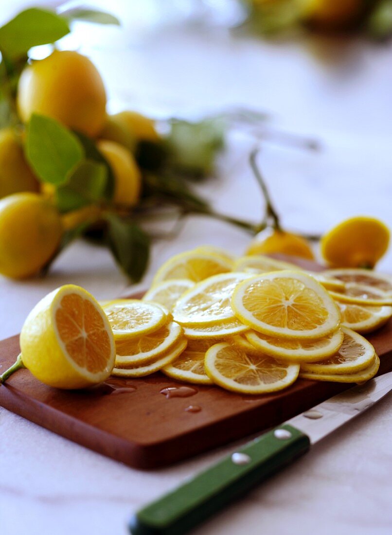 Thinly Sliced Lemons on a Cutting Board