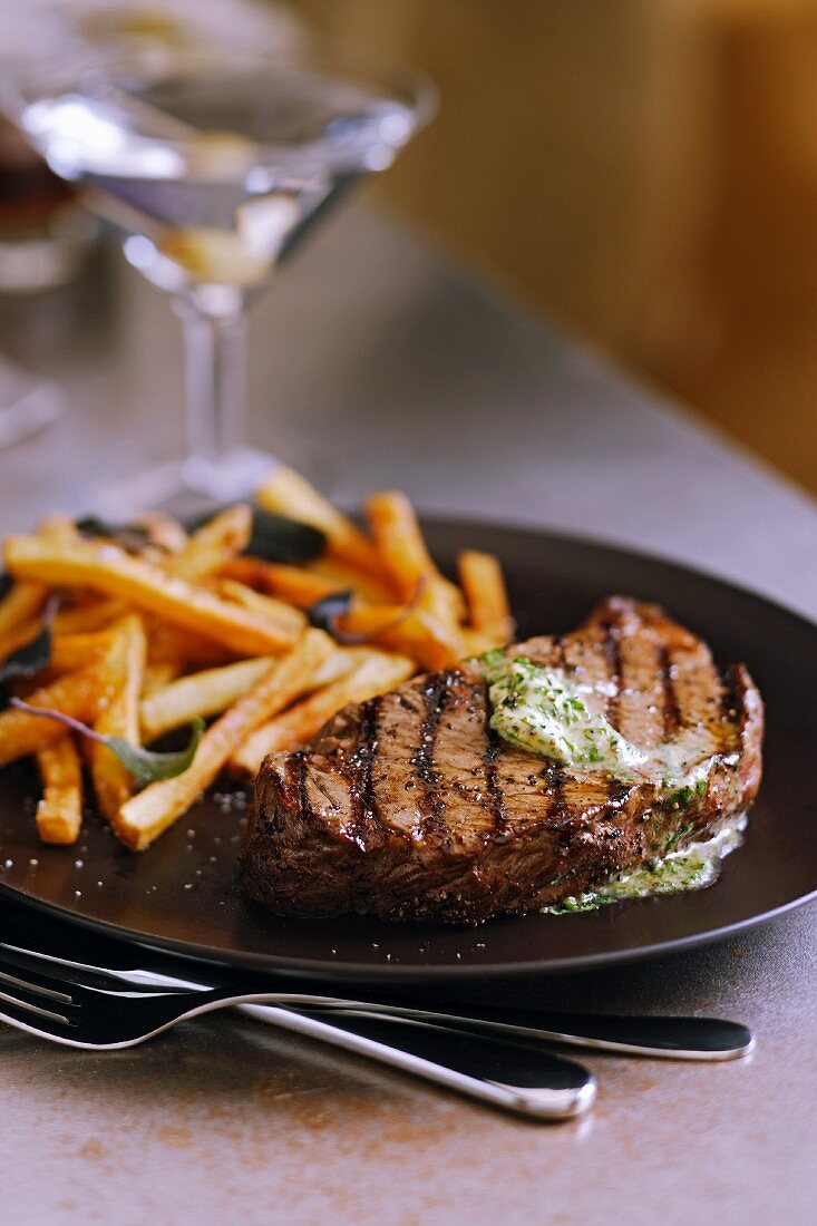 Grilled Steak with Herbed Butter and French Fries