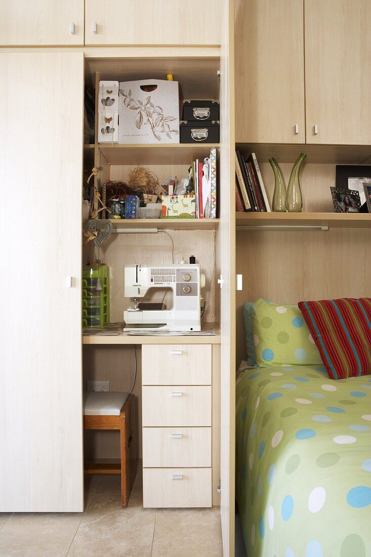 Workstation in modern bedroom - fitted wooden cupboard with integrated desk