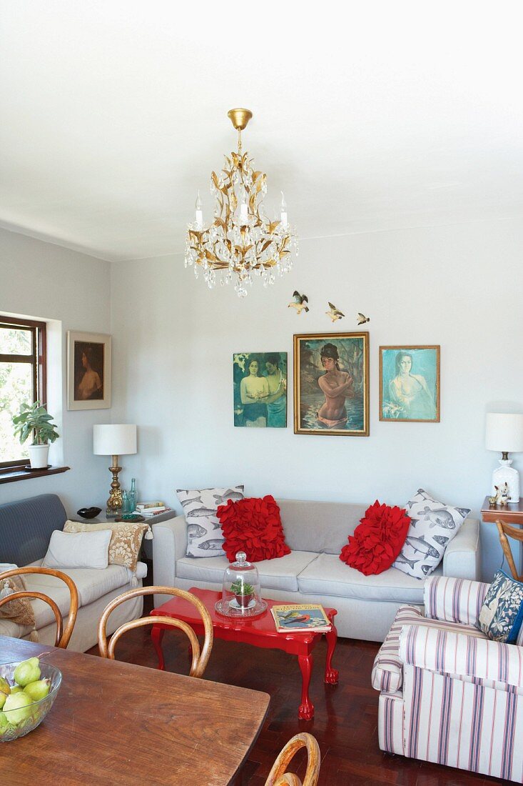 Simple interior with rustic dining room and Thonet chairs in front of upholstered armchairs in living area