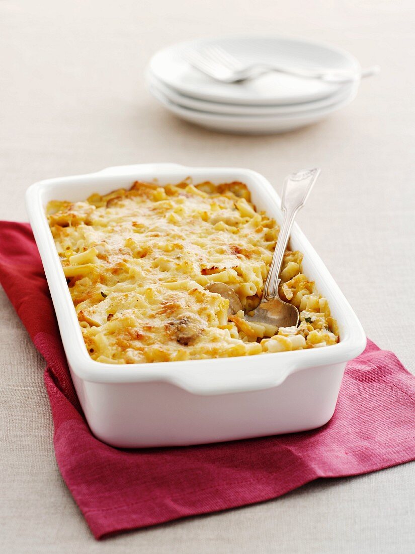 Casserole with macaroni, chicken and mushrooms in a baking dish