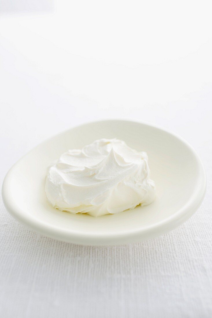 Sour cream in a small flat bowl