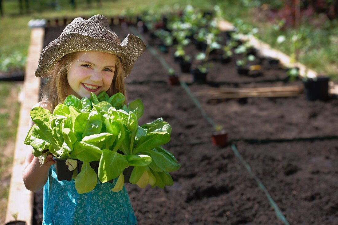 Young girl planting vegetables