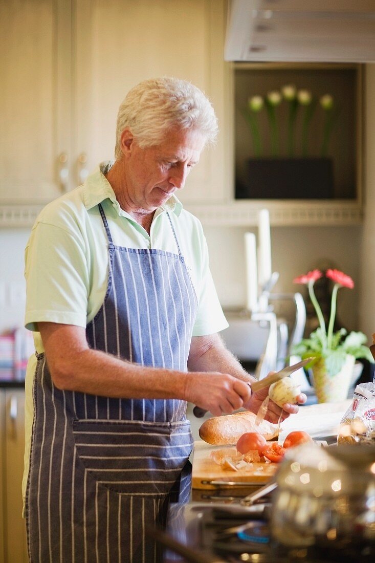 Older man cooking in kitchen